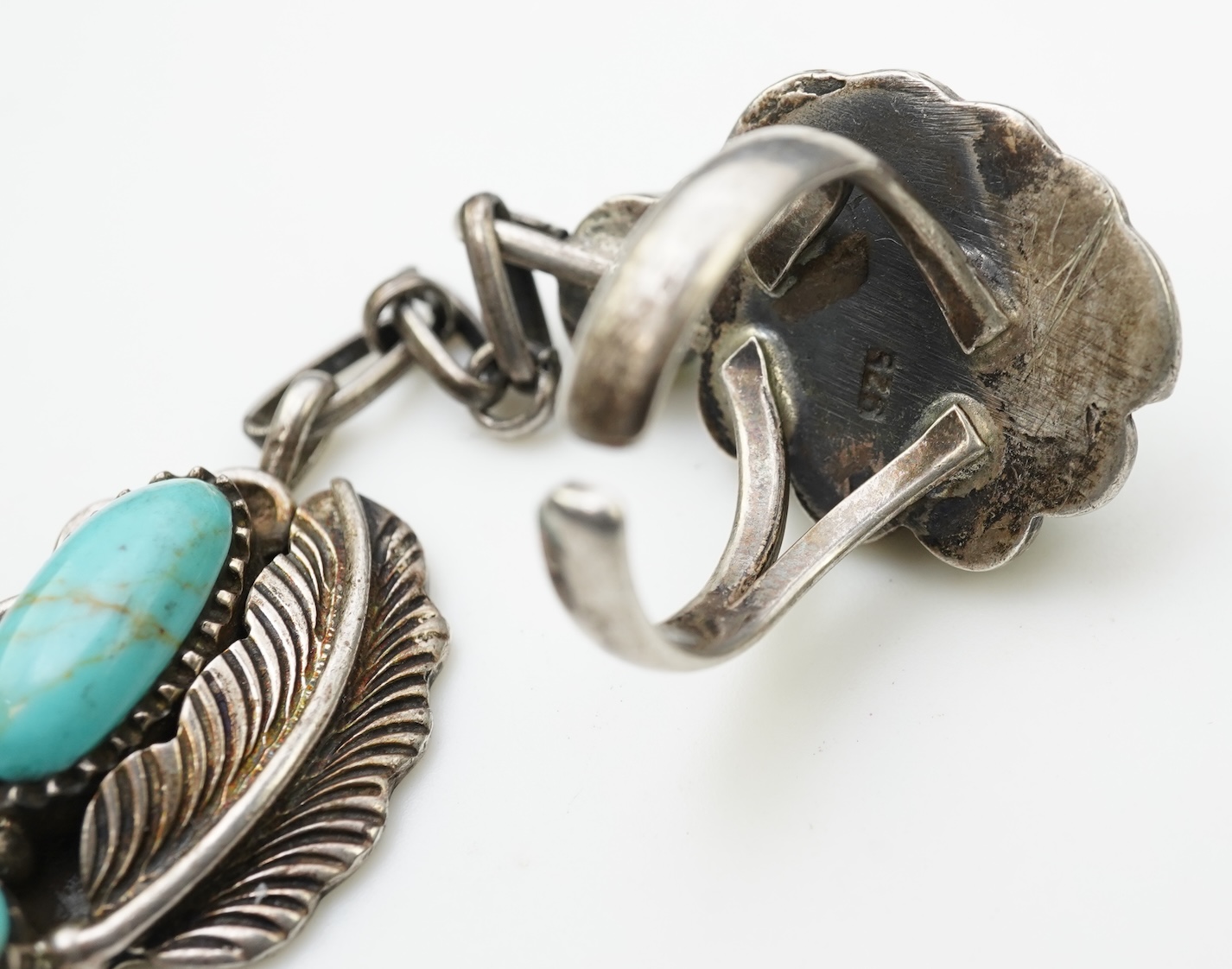 A collection of silver jewellery including a Zuni bangle